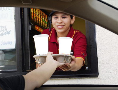 Girl serving drinks at fast food restaurant